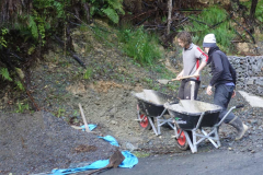 Ned and Rod pulling out some of the landslide rubble to use as fill in the new car park space.