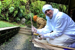 Anagarika McBain tries his hand at making a broom.