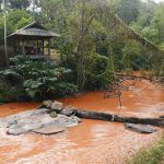 Our first rest shack with the river running red from some upstream excavations. It was a very cooling bath.