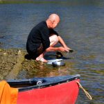 Ajahn Sucitto doing dishes. Note the band of duck tape on his foot. This was a common medical solution during the trip.