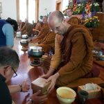 Ajahn Kevali receiving offerings.