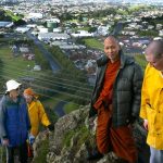 The Paritutu rock summit has been reached. New Plymouth in behind.