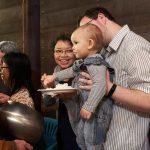 A young donor offers rice to Ajahn Kusalo.
