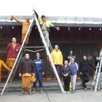The new canopy is secured and the team poses prior to tea.