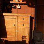 The totara cupboard front in Ajahn Kusalos kuti gleams in the late afternoon sun.