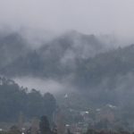 Looking up Stokes Valley to the monastery. The stupa can be seen low-centre with the hills rolling back into a winters mist.