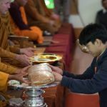 Luang Por Poi receives a robe.