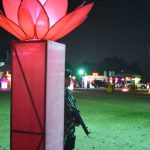 An evening UN delegates tour of international Vesak lights. A lightly armed gaurd - gaurds us from... something?