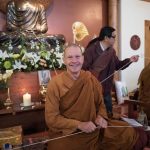 Setting up for the Paritta chanting. Ajahn looks happy.