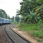 The train slowly climbs through lush countryside.