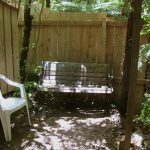 A new screen fence for the old sauna. Bench and chair sun and shade.