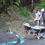 Ned and Rod pulling out some of the landslide rubble to use as fill in the new car park space.