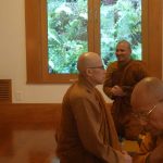 The venerable sangha settling for Sunday dana.