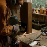 Ajahn Dta in metal-man mode working on the new donation box.