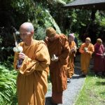 The Sangha leads the procession from the sala up to the stupa.