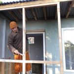 Venerable Dhammavasa applying the first coat to the new kuti porch frame. This panel will eventually be sheathed with clear acrylic sheet.