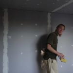 Joshua working on the plastering of the new monk kuti.