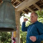 Simon rings the bell to invite everyone to assemble in the hall.