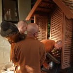 The Buddha rupa being eased into position; ground level of the monks vihara.