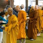 Luang Por Poi leads the sangha on alms round in the cloister.