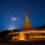 Stupa circumambulation with a clear moon rising.