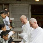 Anagarikas receiving alms food.