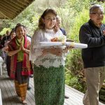 The procession around the sala with Khun Siriwam carrying the forest cloth to be offered.