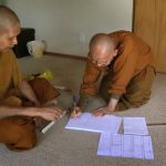 Ajahn Kongrit introducing venerable Kusalacitto to the craft of robe-making.