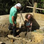 Setting steel restraining rods. Having the wall fall over is best avoided.