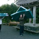 The newly ordained Anagarika Ryan and Jamie carrying mattresses to kutis for the retreat.