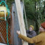 The concrete lotus bud being raised into position at the monastery front entrance.