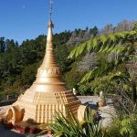 Late afternoon sun and the full moon of Magha shine on the stupa.