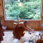 The sangha giving the Chao Khun kuti a deep clean.