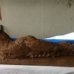 The clay model which will become the reclining Buddha rupa in the memorial grove.