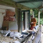 Ajahn Jo with hammer in de-nail mode? The Garden kuti almost ready for some digging to get the floor all on one level.