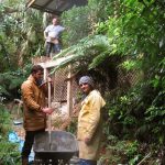 James and Daniel mixing concrete for the deck support foundations as part of the Chao Khun kuti renovation. Bruce watches from above.