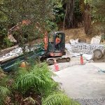 The lower section of the landslide has been levelled and drained. Gabion baskets are being built to retain any future slippage.