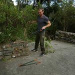 Christian clearing the vegetation around the existing stonework on the west side of the stupa. This view will change dramatically over the next several months.