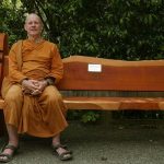 Ajahn Kusalo testing the new memorial bench in the sala courtyard.