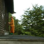 Ajahn Dta - on his birthday - cleaning the dana sala windows.