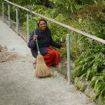 Sister Rohini clearing the moss and debris on the sala ramp.