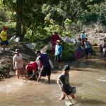 A new road has been cut into the monastery. The project is to cast a concrete road out of the river. Villagers digging gravel-sand out of the river.