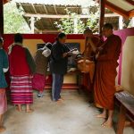 Alms is offered in a small pavilion on the edge of the village.