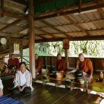 The two lay stewards with the sangha at meal time.