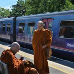 Ajahn Cunda (with coffee) and venerable Tithapunyo ready to board the train.
