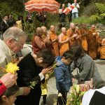 Offerings being made at the stupa. The monks chant rounds of Itipi so...