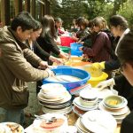 Many hands help with the washing up after our shared meal.