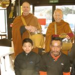 Two lads (front L&R) spend holiday time at the monastery and join the monks for pindapat in Stokes Valley.