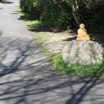 The rock at the edge of the lower carpark - with Buddha.