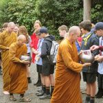 Fifty students from Kapiti College offer alms to the sangha as part of their recent visit.